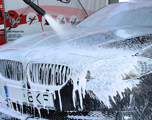 a car with a high pressure washer